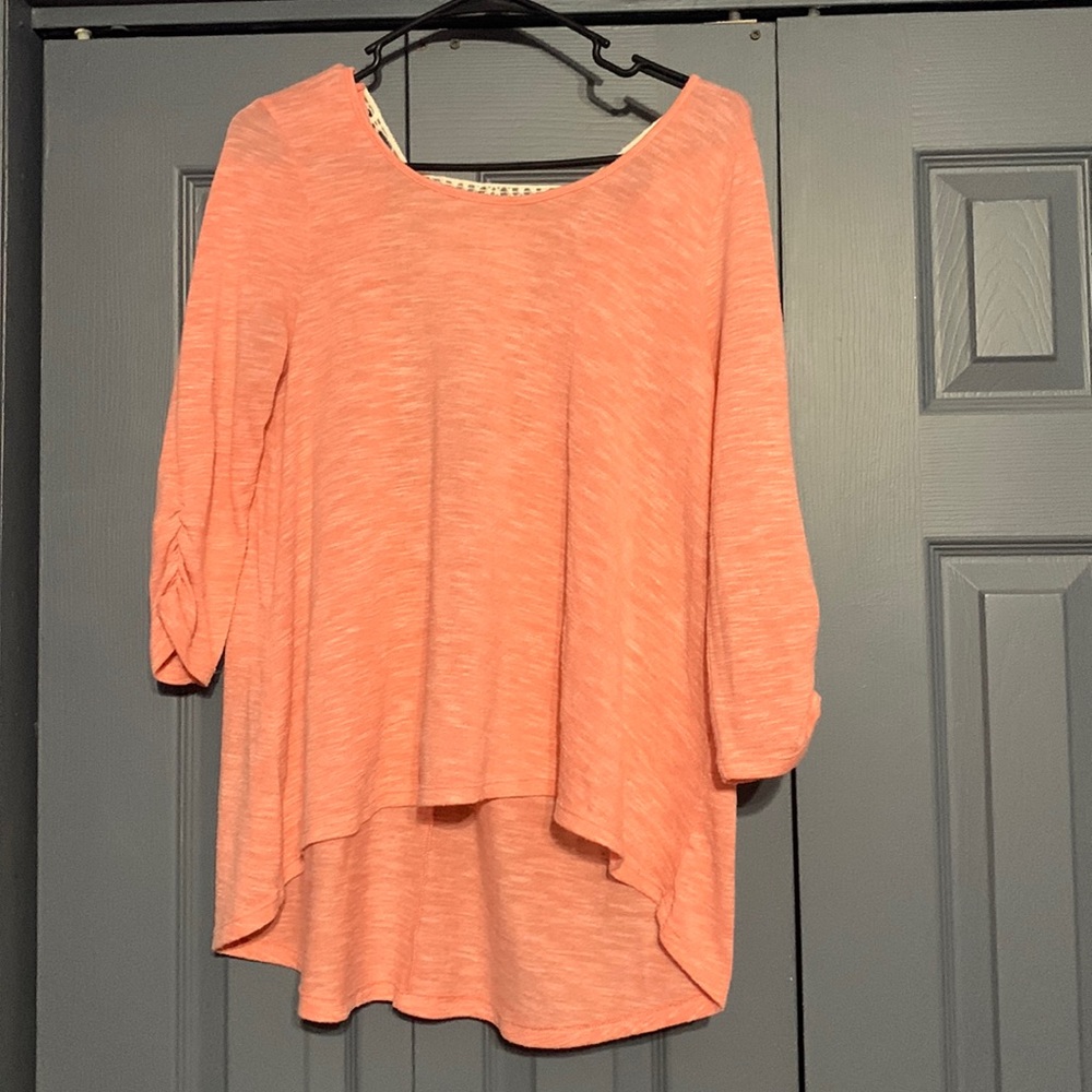 Heathered pink high low top. Lace back detail. Size: M